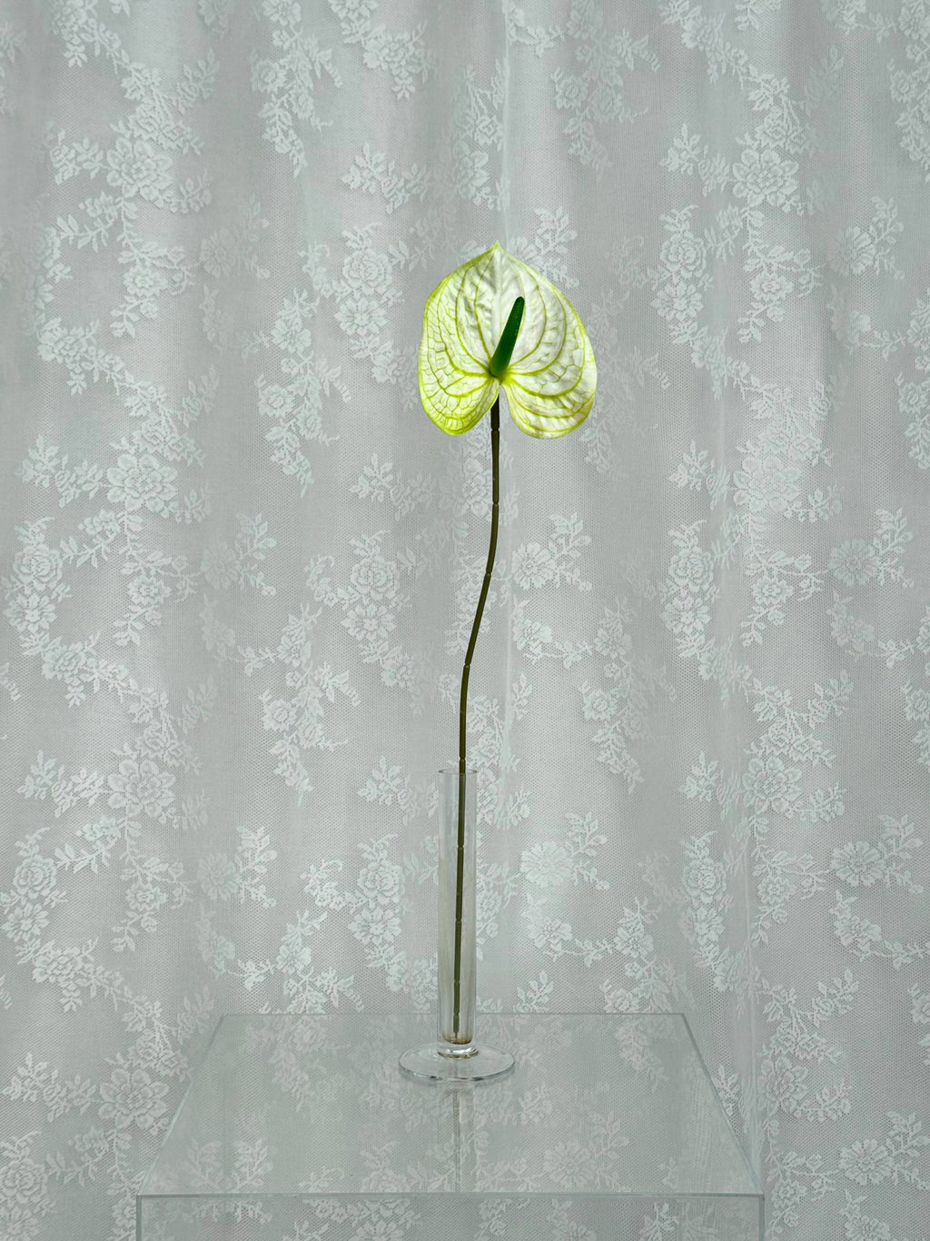 Artificial large anthurium flower by Fleuristic, showcasing vibrant red petals and lush green leaves for decorative use.