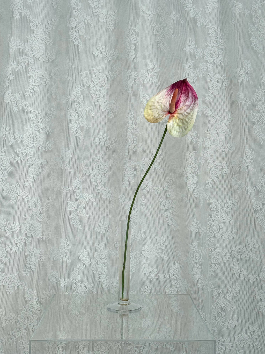 Artificial large Anthurium flower by Fleuristic with vibrant red petals and lush green leaves.