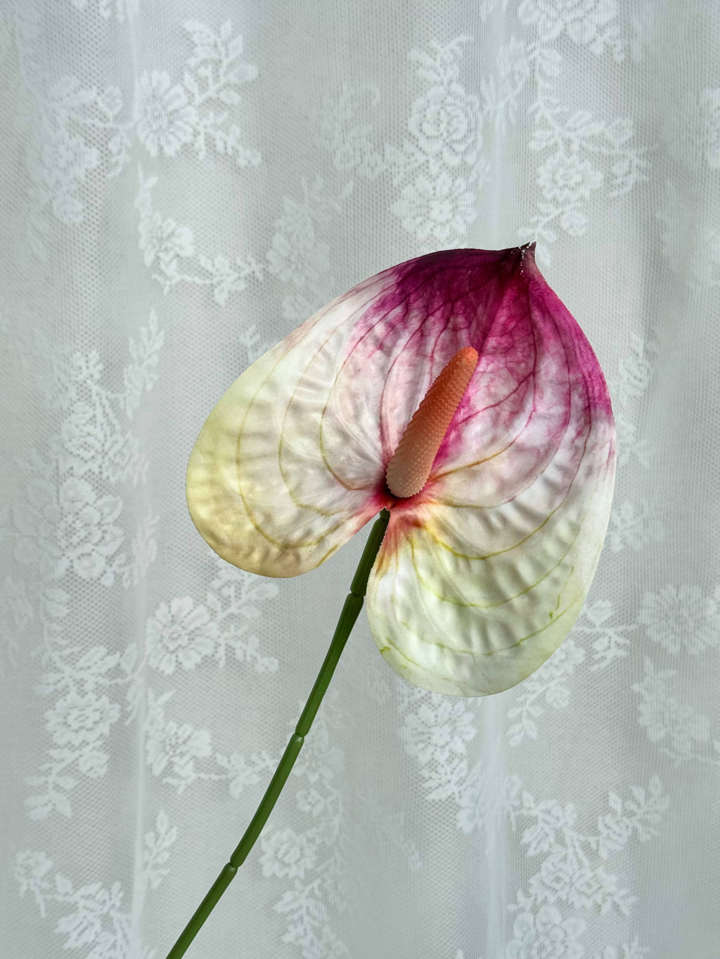 Artificial large Anthurium flower by Fleuristic with vibrant red blooms and lush green leaves, realistic faux plant for home decor.