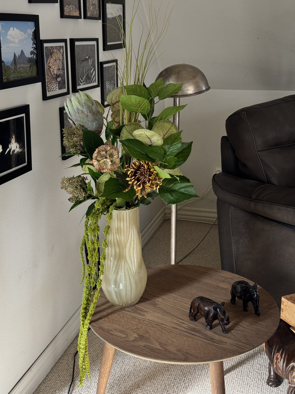 Fleuristic Green Forest artificial flower bouquet with lush green foliage and detailed leaves in a cozy indoor setting