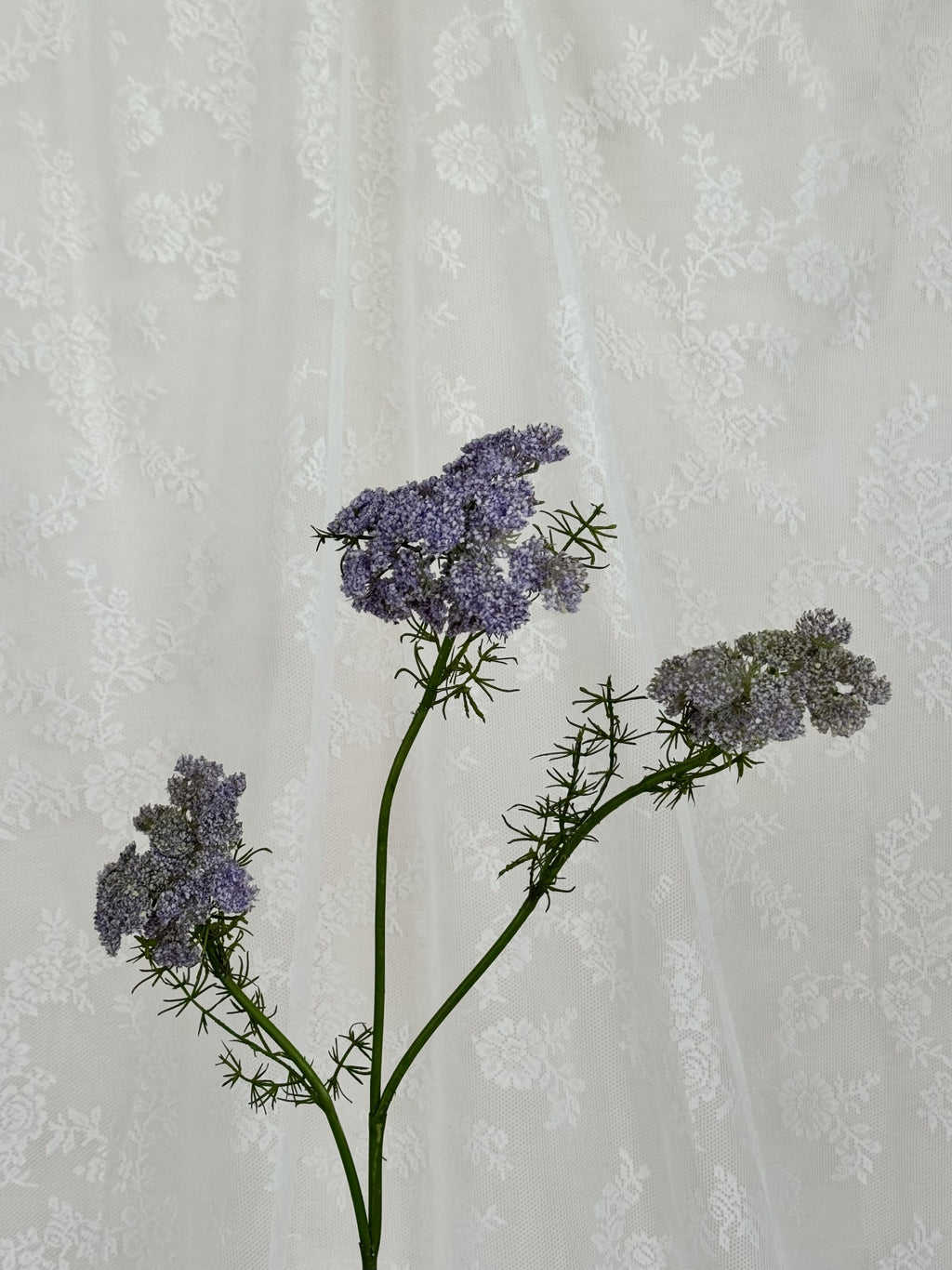 Close-up of a purple artificial wild carrot flower by Fleuristic, showing detailed petals and realistic texture.