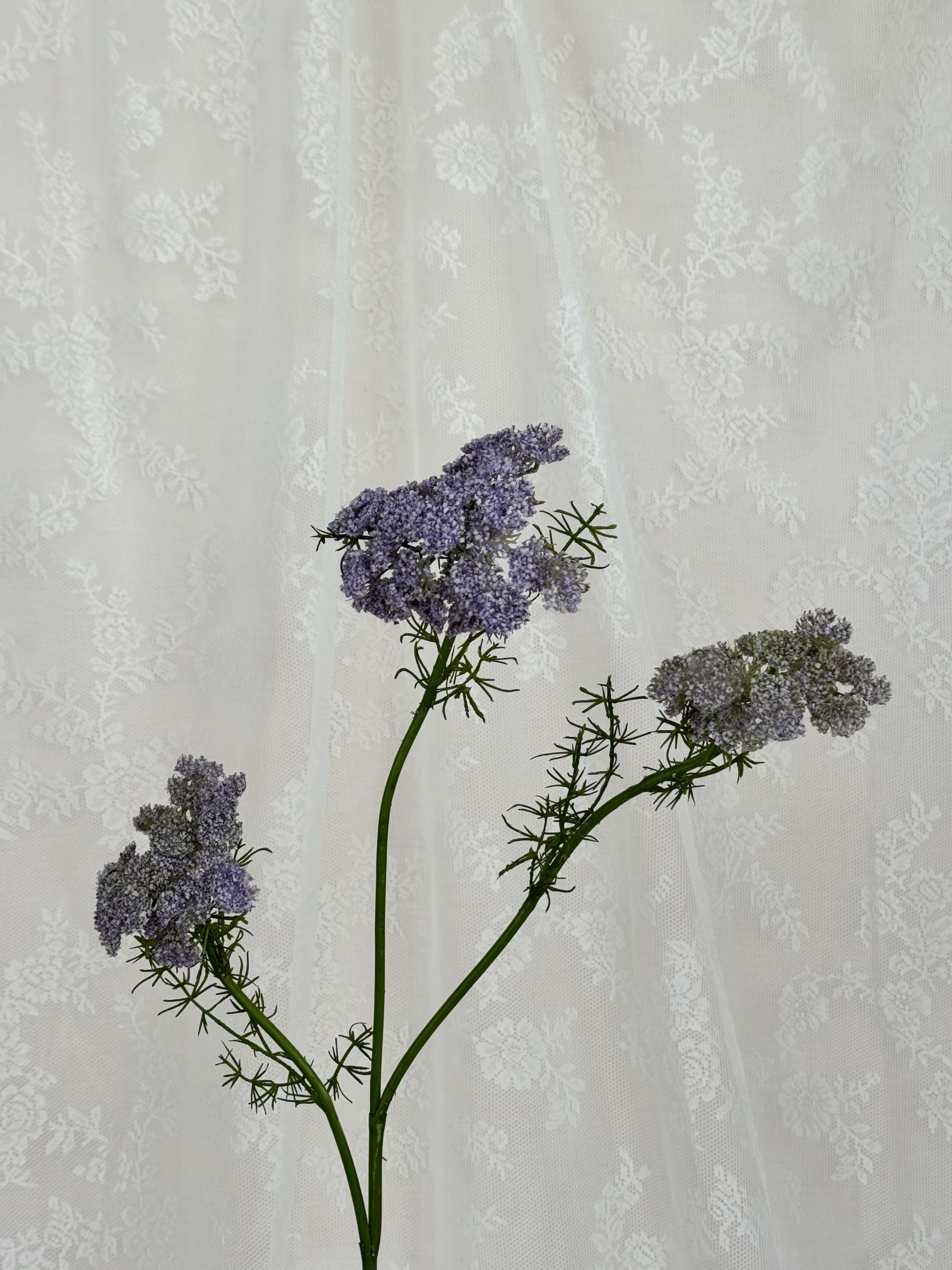 Close-up of a purple artificial wild carrot flower by Fleuristic, showing detailed petals and realistic texture.