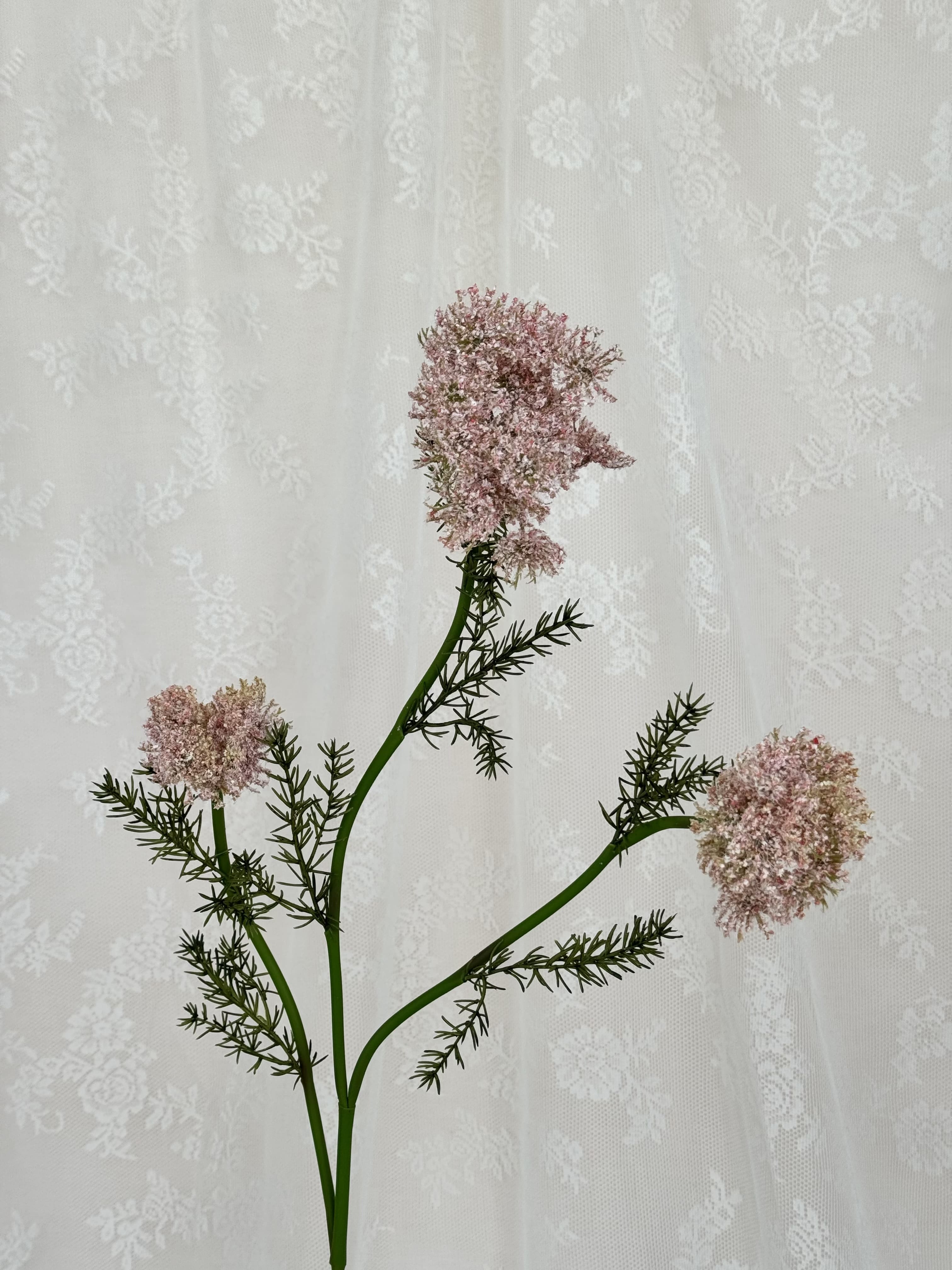 Close-up of a yellow artificial wild carrot flower from Fleuristic, showing detailed petals and natural-looking texture.