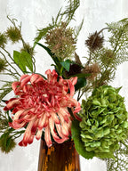 Fleuristic Amber Essence artificial bouquet with warm-toned flowers in a decorative arrangement for home decor.