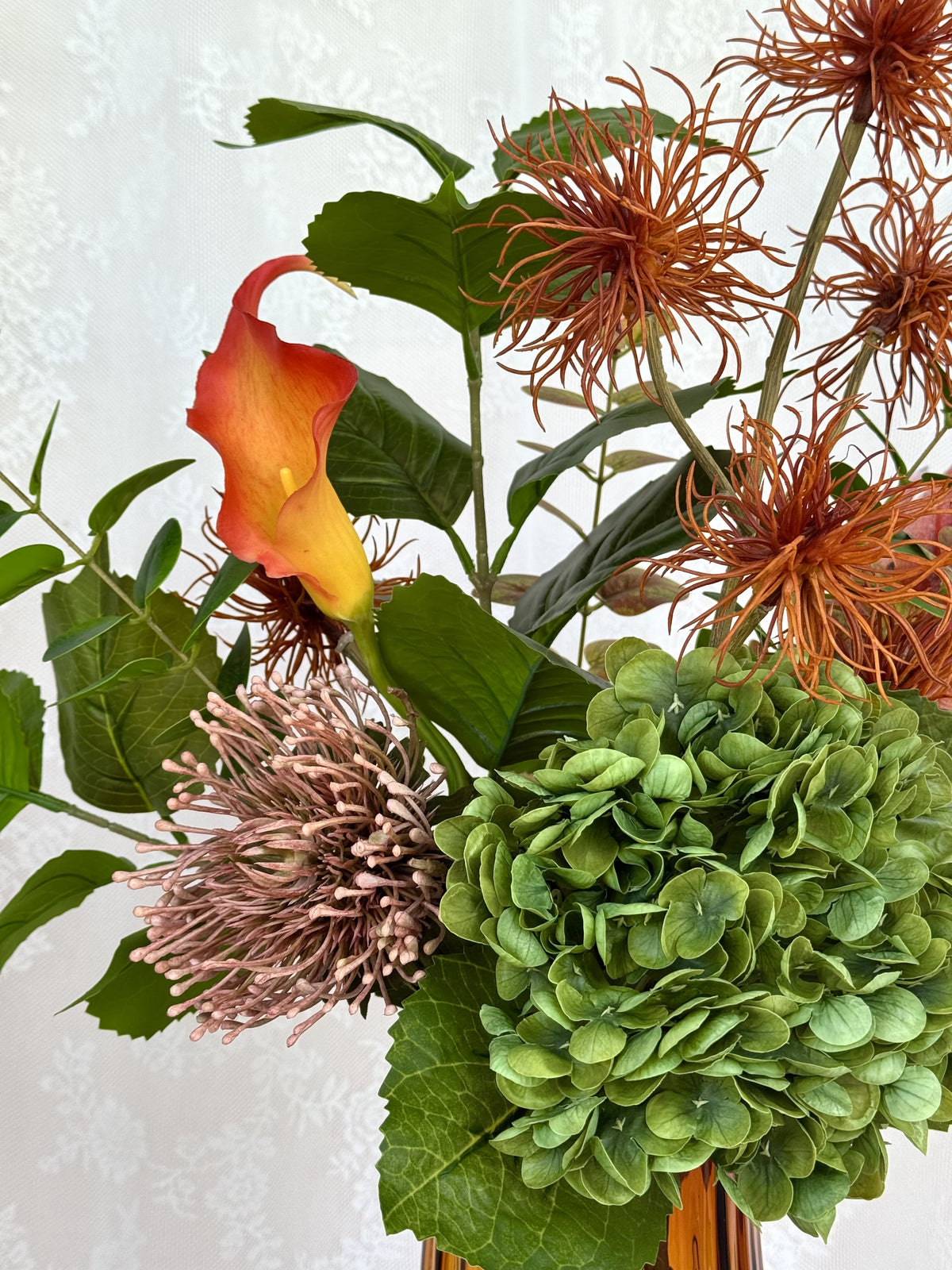 Fleuristic Autumn Affair artificial flower bouquet with warm autumn-colored leaves and foliage in a natural arrangement.