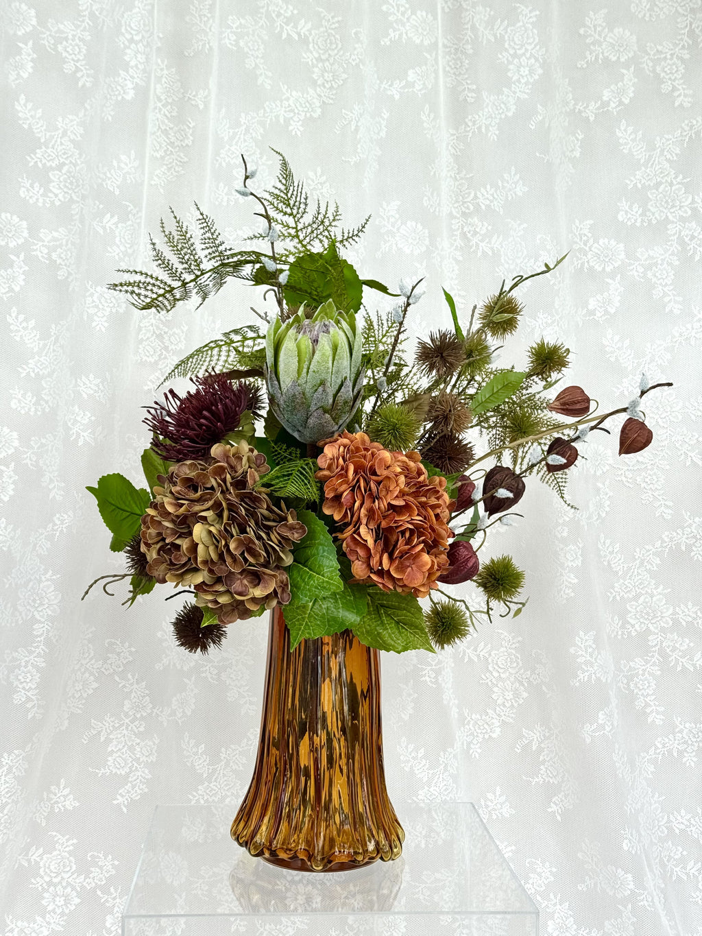 Artificial autumn bouquet named Autumn Muse by Fleuristic, featuring vibrant fall-colored leaves and floral elements.