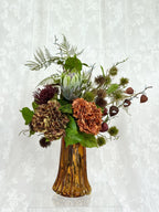 Artificial autumn bouquet named Autumn Muse by Fleuristic, featuring vibrant fall-colored leaves and floral elements.