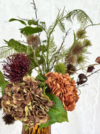 Fleuristic Burnt Harmony artificial flower bouquet with warm-toned, realistic faux flowers in a dense arrangement.