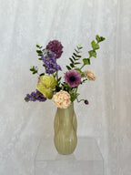 Artificial bouquet of Champagne Harmony flowers by Fleuristic with vibrant, realistic blooms arranged in a stylish display.