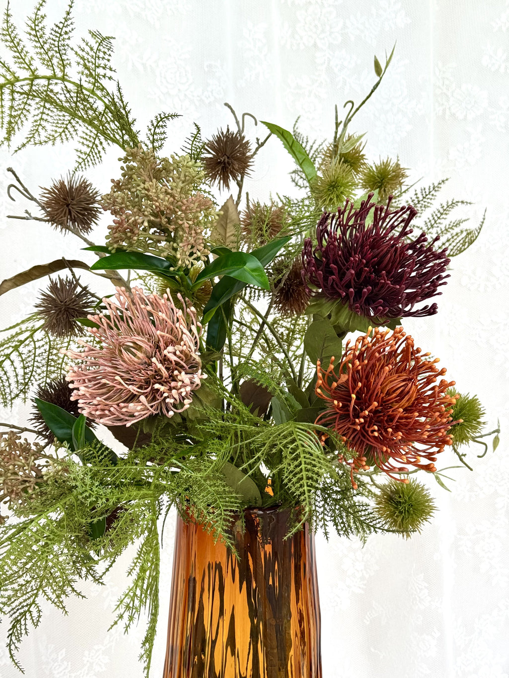 Artificial floral bouquet titled "Earthy Feelings" by Fleuristic, featuring natural-toned flowers and greenery.