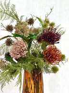 Artificial floral bouquet titled "Earthy Feelings" by Fleuristic, featuring natural-toned flowers and greenery.