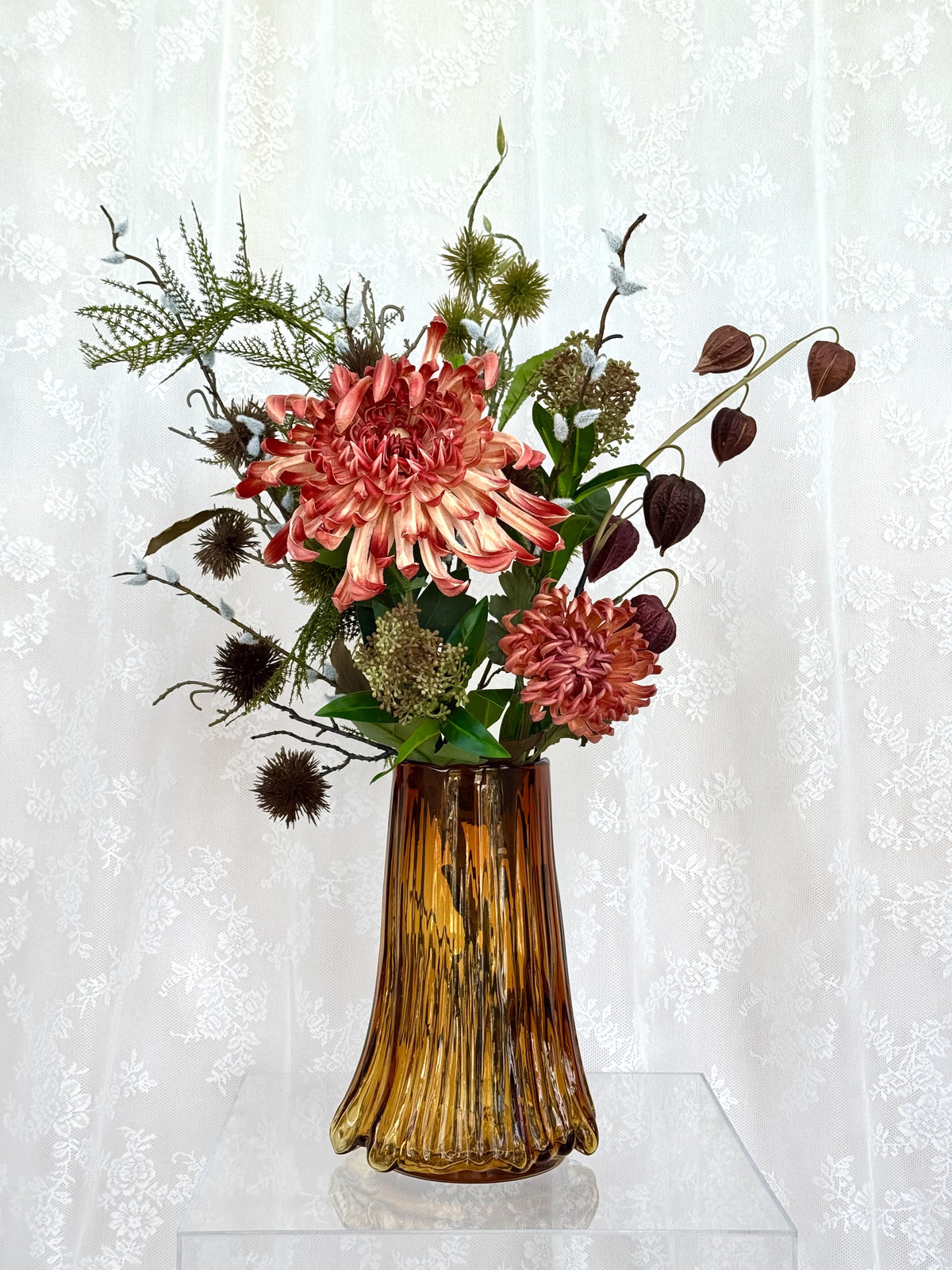 Artificial floral arrangement featuring maple leaves and spice accents in a bouquet by Fleuristic.