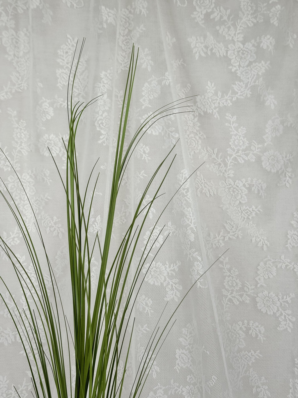 Fleuristic artificial green grass (siv) with detailed lush blades, ideal for home decor or landscaping accents.
