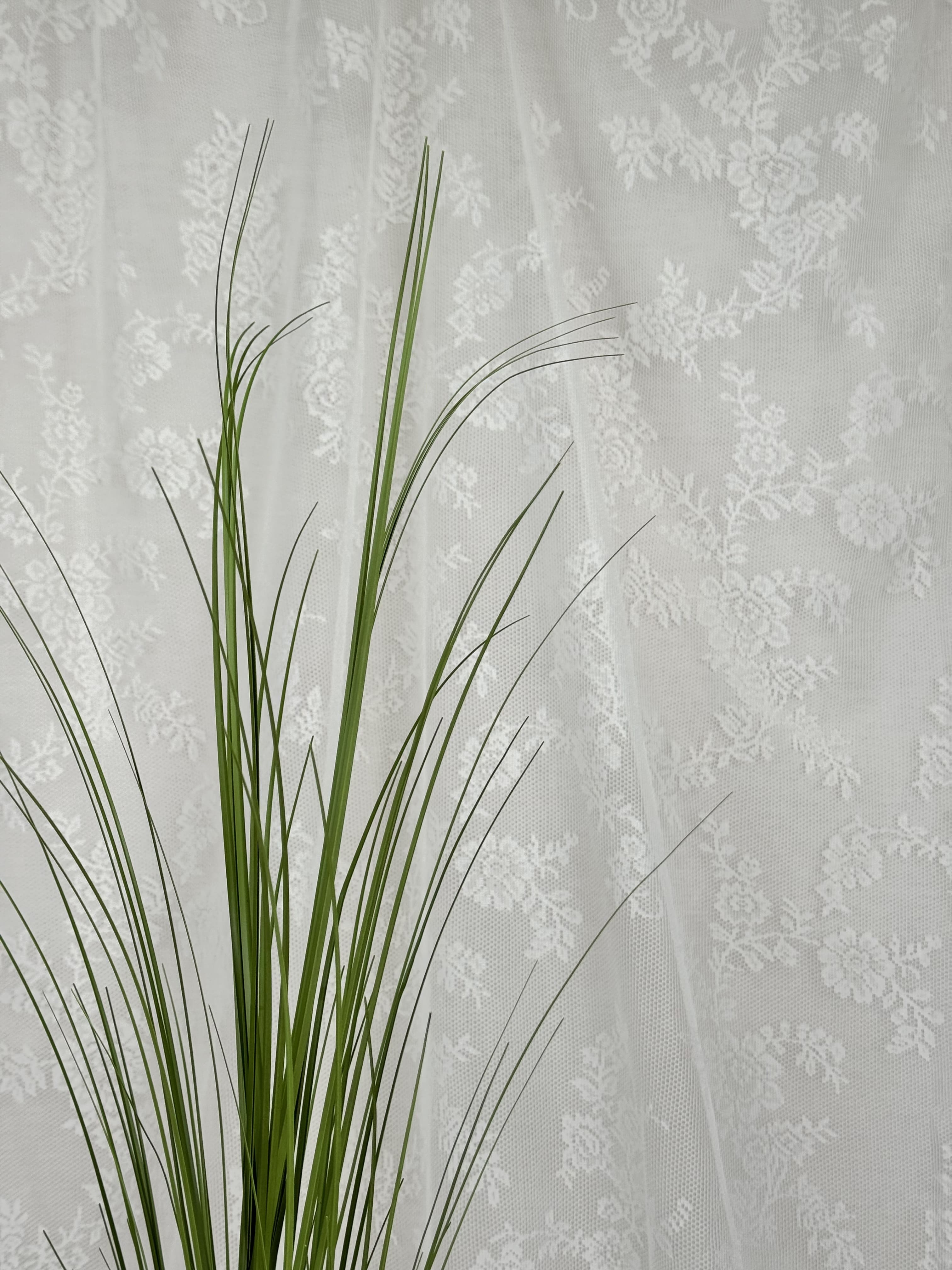 Fleuristic artificial green grass (siv) with detailed lush blades, ideal for home decor or landscaping accents.