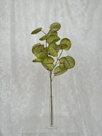 Fleuristic artificial green and red blades with realistic leaf detailing on a natural background.