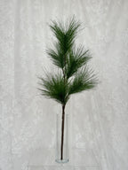 Fleuristic artificial fir branch with green pine needles, realistic artificial greenery for holiday decorating.