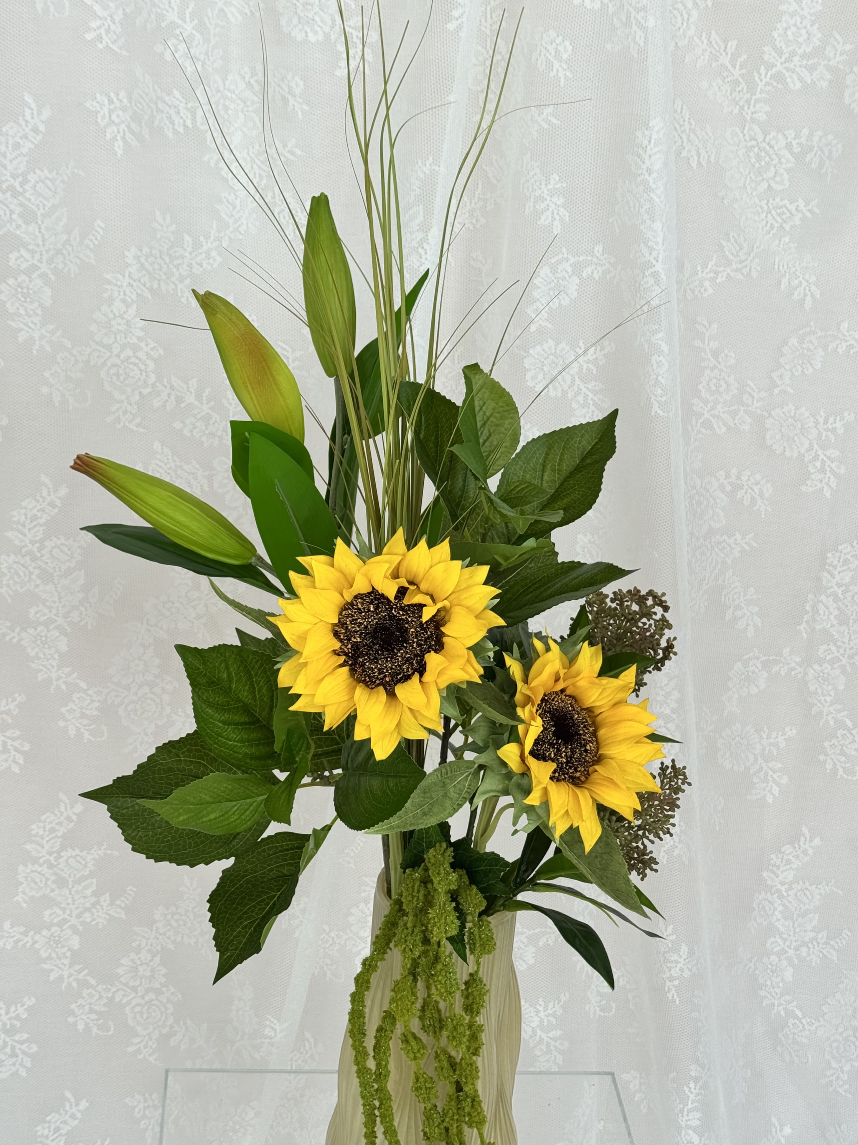 Fleuristic sunflower greens artificial bouquet with vibrant yellow sunflowers and green foliage in a detailed close-up image.