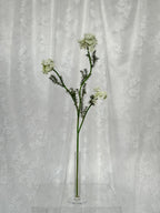 Artificial wild carrot flower by Fleuristic, showcasing realistic orange and green hues with detailed petal and foliage textures.