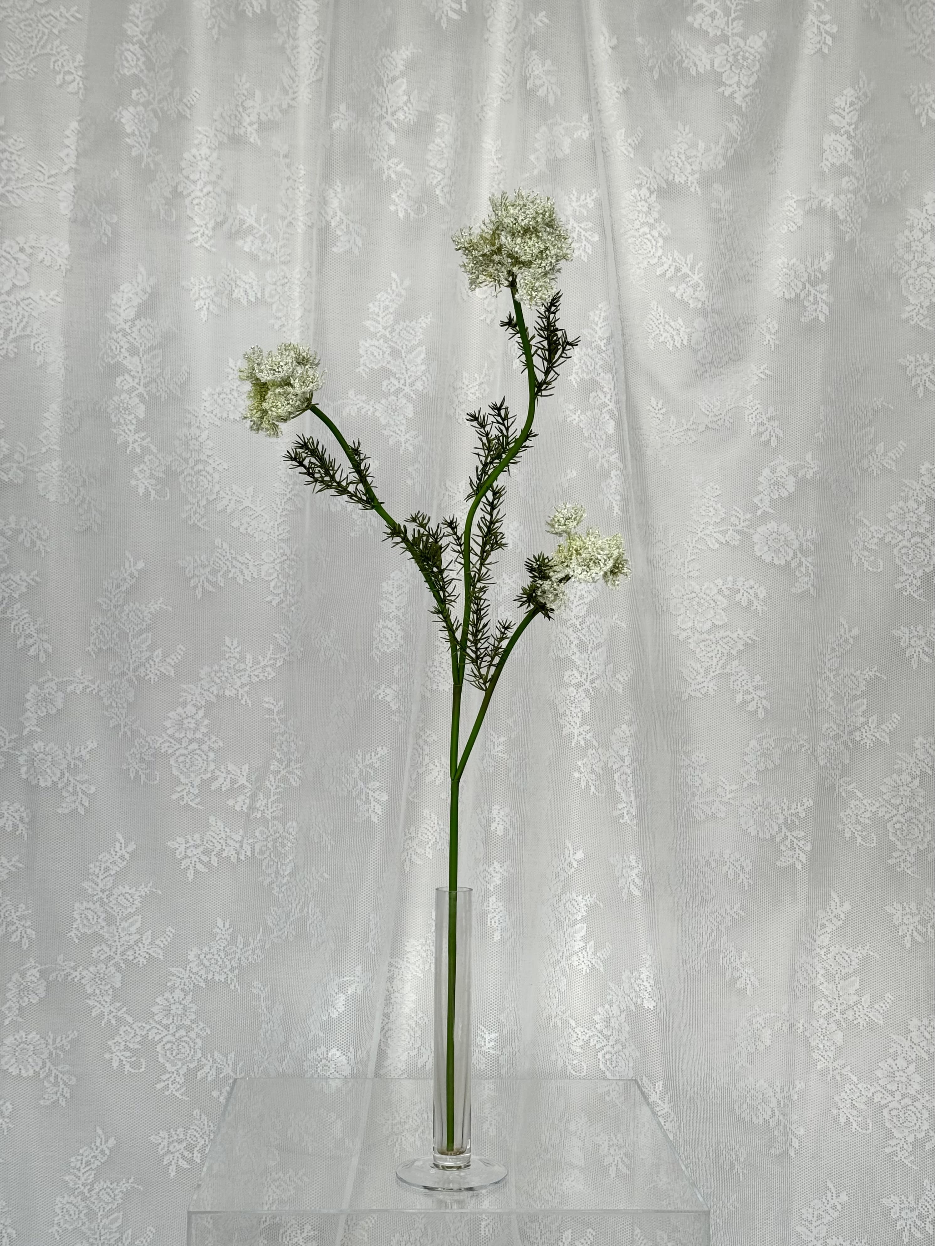 Artificial wild carrot flower by Fleuristic, showcasing realistic orange and green hues with detailed petal and foliage textures.